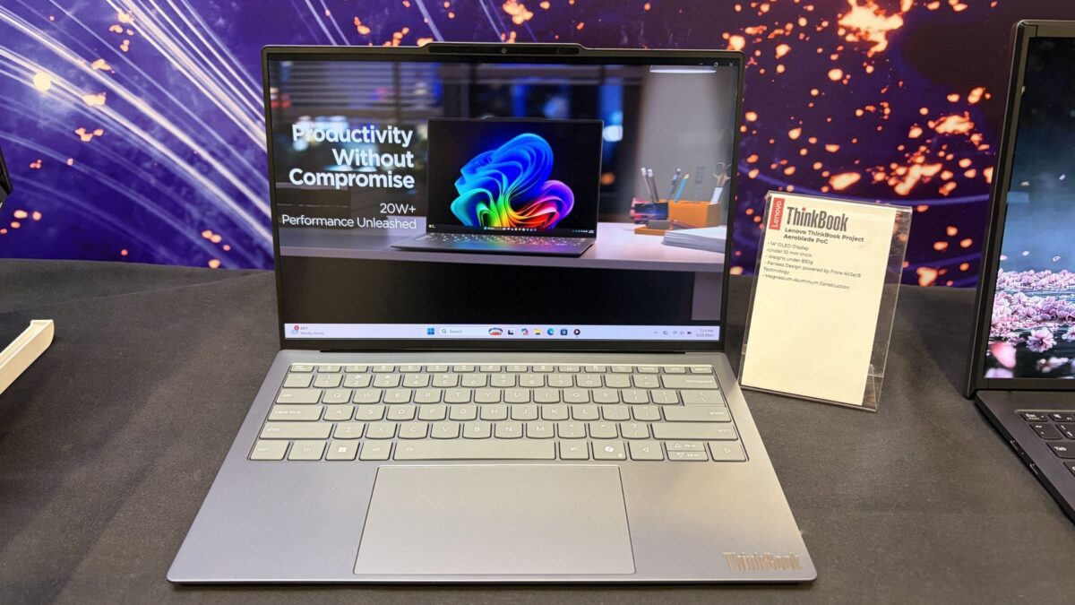 Lenovo Project Aeroblade laptop on display table, showing colorful abstract artwork and “Productivity Without Compromise” beside an information card.